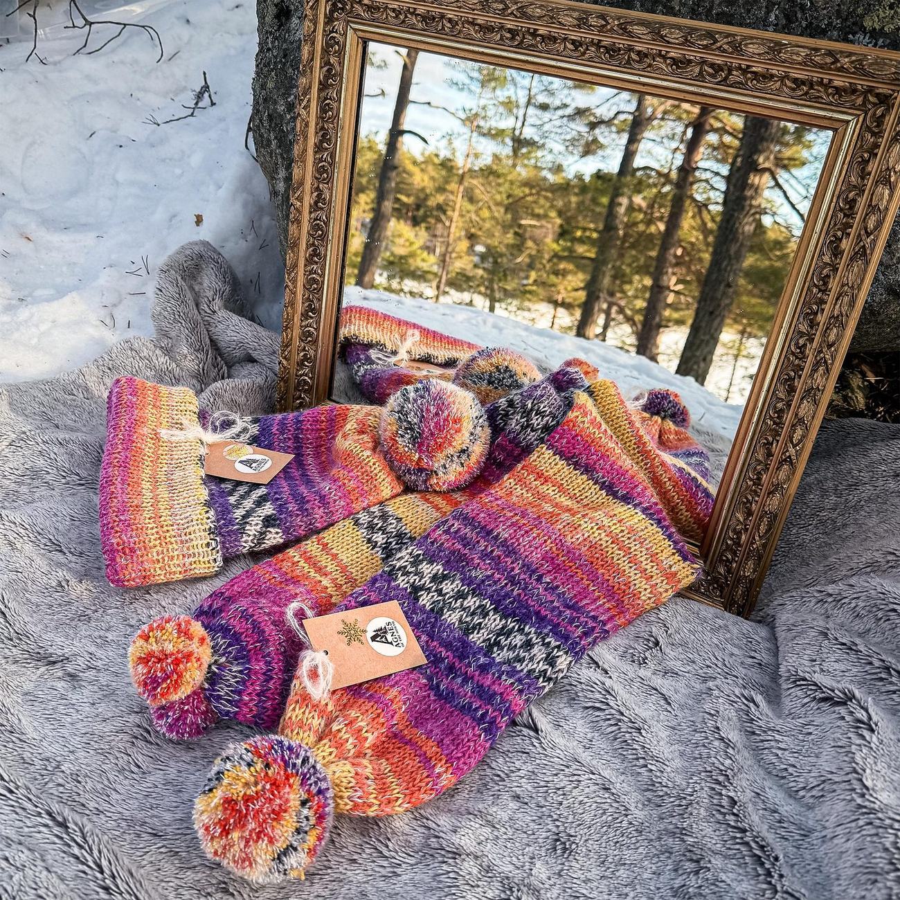 The sunset stripes set lying before the gilded mirror on a sheepskin in the snow